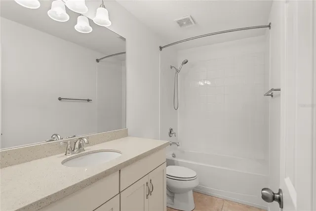 a bathroom with a granite countertop sink a toilet and a bathtub