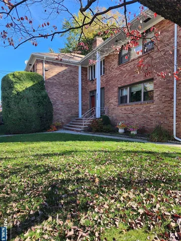 a view of a brick house with a yard