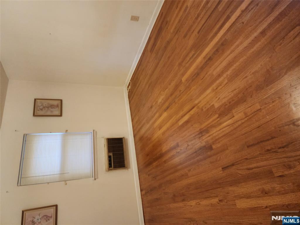 911-921 Teaneck Road, Unit B1 Teaneck, NJ 07666 - Photo 3 of 12 a view of empty room with wooden floor and kitchen view