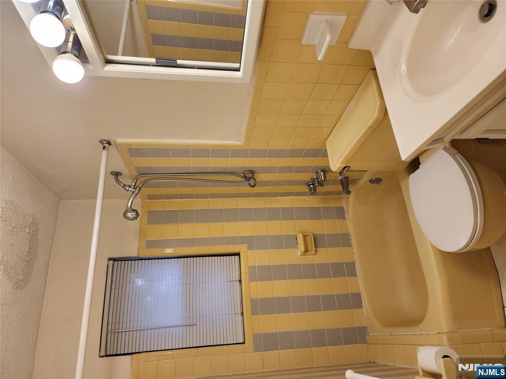 911-921 Teaneck Road, Unit B1 Teaneck, NJ 07666 - Photo 5 of 12 a bathroom with a sink toilet and shower