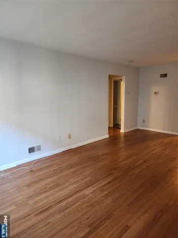 a view of an empty room and wooden floor