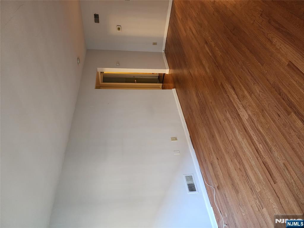 911-921 Teaneck Road, Unit B1 Teaneck, NJ 07666 - Photo 6 of 12 a view of an empty room and wooden floor