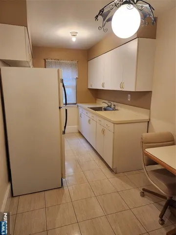 a kitchen with a stove cabinets and a refrigerator