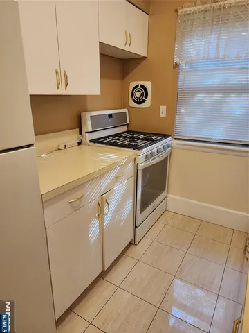 a kitchen with a stove and a refrigerator