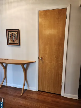 a view of a small space with wooden floor and a ceiling fan