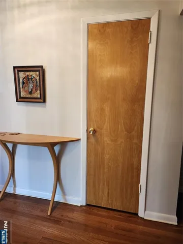 a view of a small space with wooden floor and a ceiling fan
