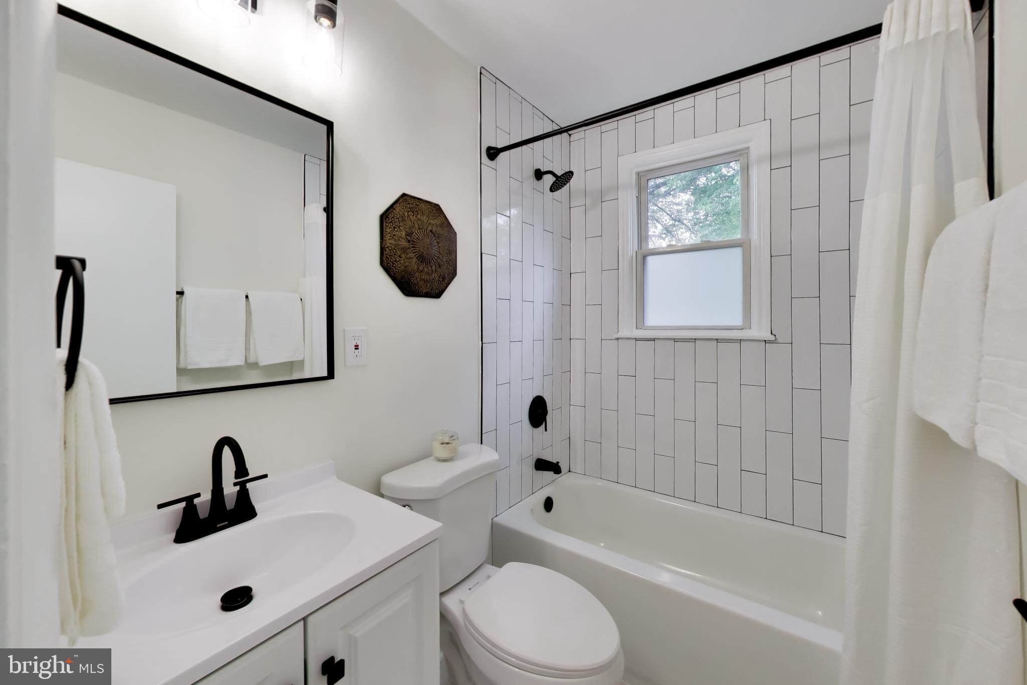 11309 Keystone Avenue Clinton, MD 20735 - Photo 19 of 36 a bathroom with a sink a toilet and a mirror