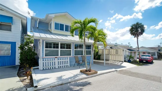 a view of a house with a porch next to a road