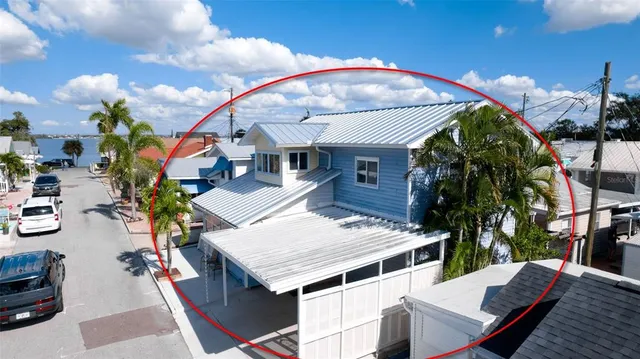 an aerial view of a house with swimming pool and patio