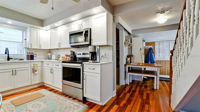 a kitchen with stainless steel appliances a stove a sink and a refrigerator
