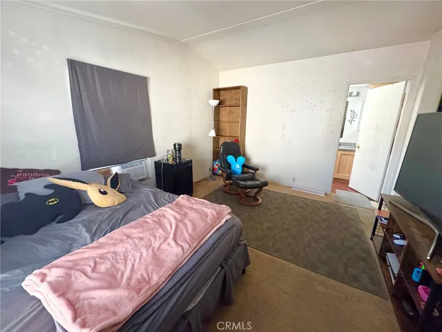 a bedroom with bed and a mirror