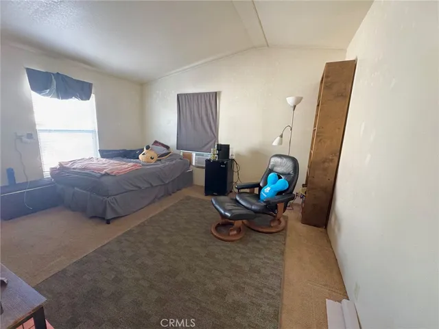 a bedroom with bed and a window