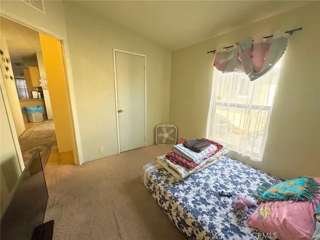 a bedroom with a bed and a chair