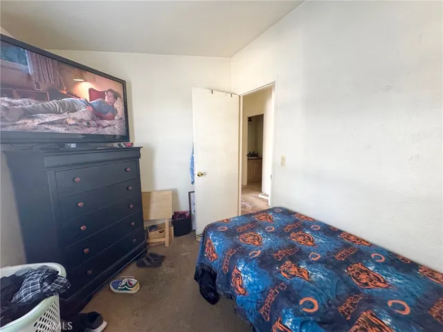 a bedroom with a bed and a dresser