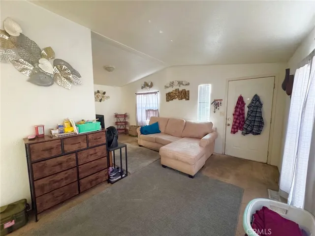 a living room with furniture and painting on the wall