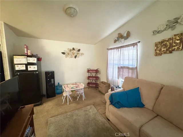 a living room with furniture rug and window