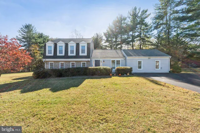 a front view of house with yard and trees around