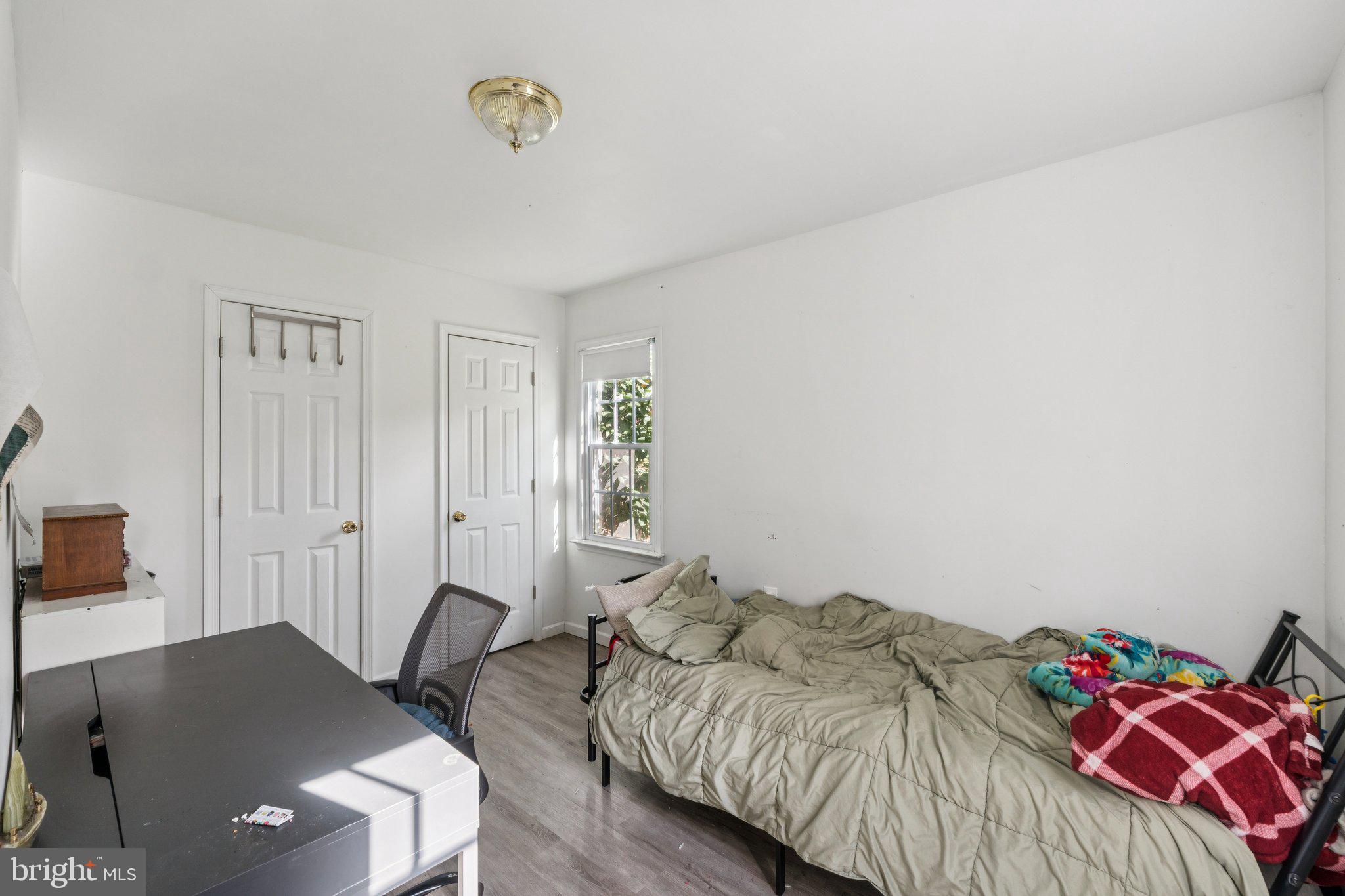 8124 Seneca View Drive Gaithersburg, MD 20882 - Photo 4 of 37 a bedroom with a bed and a table