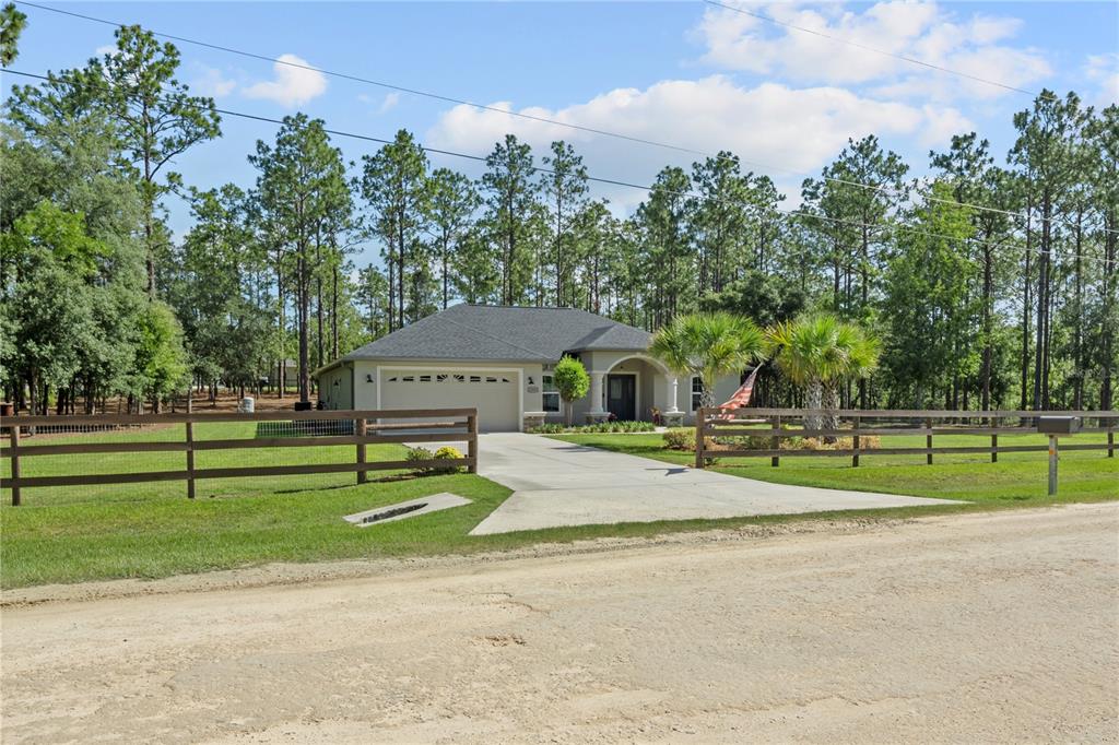 12929 Southwest 89th Street Dunnellon, FL 34432 - Photo 62 of 76 a view of a house with a big yard and large trees