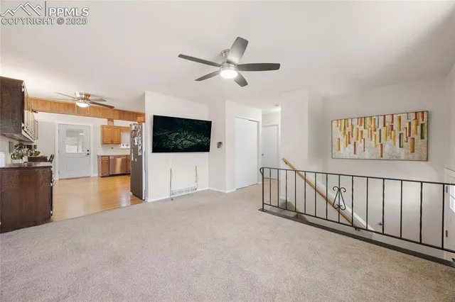 a view interior of a house with wooden floor windows and a ceiling fan