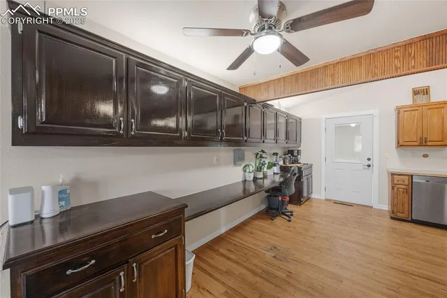 a kitchen view with wooden floor stainless steel appliances and cabinets