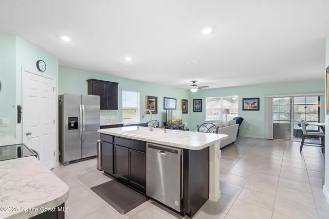 a room with a sink a table and chairs