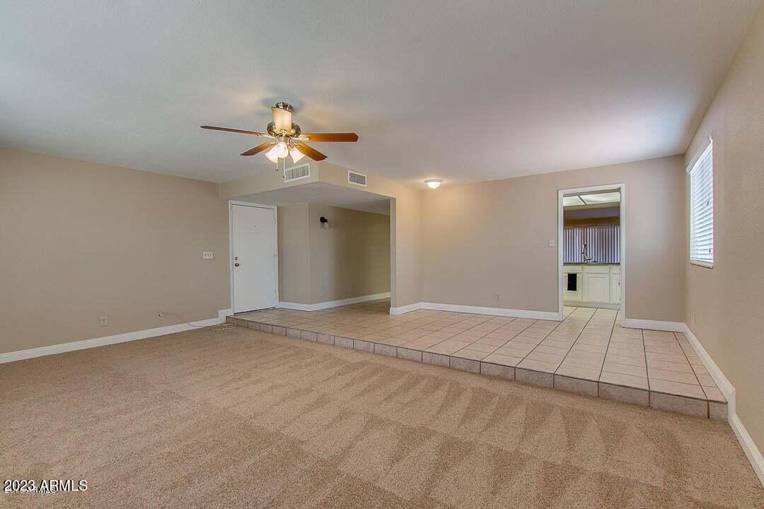 6521 West Camelback Road Phoenix, AZ 85033 - Photo 11 of 32 a view of an empty room with a chandelier fan