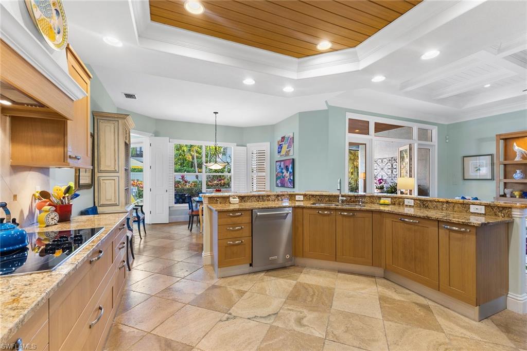 540 Ketch Drive Naples, FL 34103 - Photo 13 of 32 a large kitchen with lots of counter and chairs