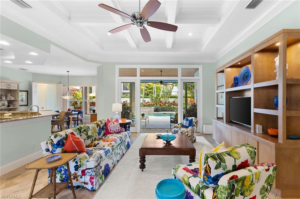 540 Ketch Drive Naples, FL 34103 - Photo 17 of 32 a living room filled with lots of furniture and a flat screen tv