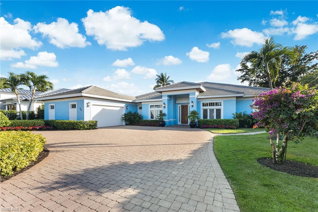 540 Ketch Drive Naples, FL 34103 - Photo 2 of 32 a front view of a house with garden