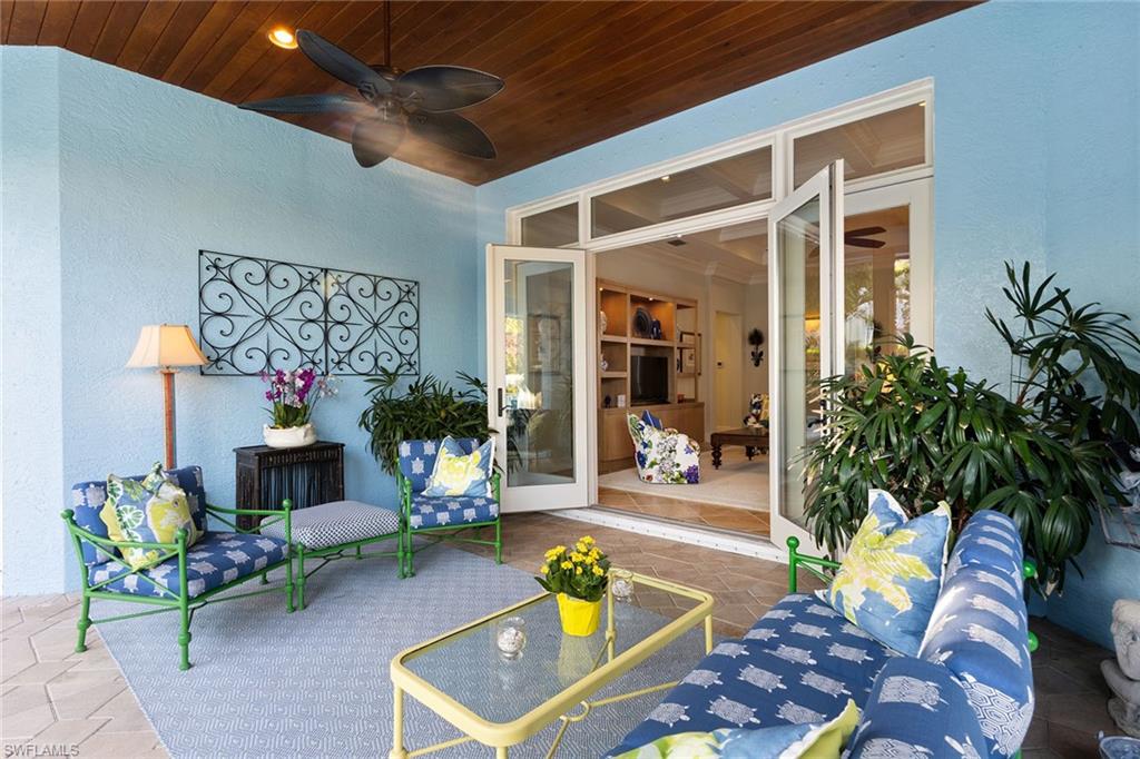 540 Ketch Drive Naples, FL 34103 - Photo 21 of 32 a living room filled with furniture and a chandelier