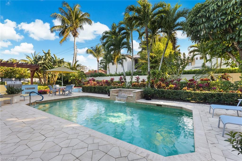540 Ketch Drive Naples, FL 34103 - Photo 22 of 32 a view of swimming pool with a table and chairs