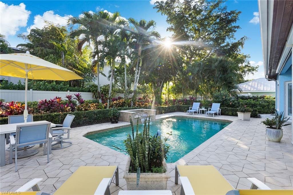 540 Ketch Drive Naples, FL 34103 - Photo 24 of 32 a view of a swimming pool with a patio