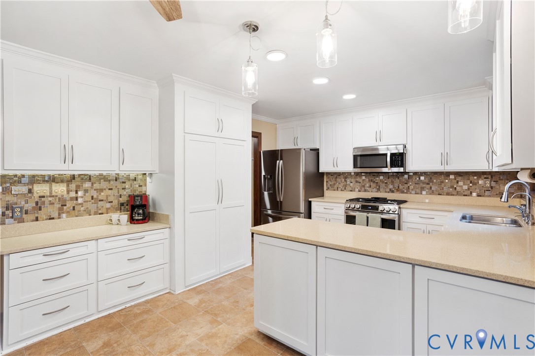 3613 Stoney Ridge Road Midlothian, VA 23112 - Photo 11 of 50 a kitchen with stainless steel appliances a refrigerator sink and white cabinets