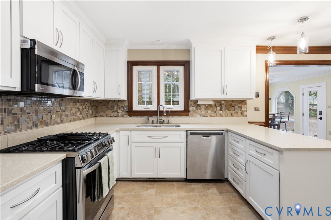 3613 Stoney Ridge Road Midlothian, VA 23112 - Photo 14 of 50 a kitchen with stainless steel appliances granite countertop a sink stove cabinets and microwave