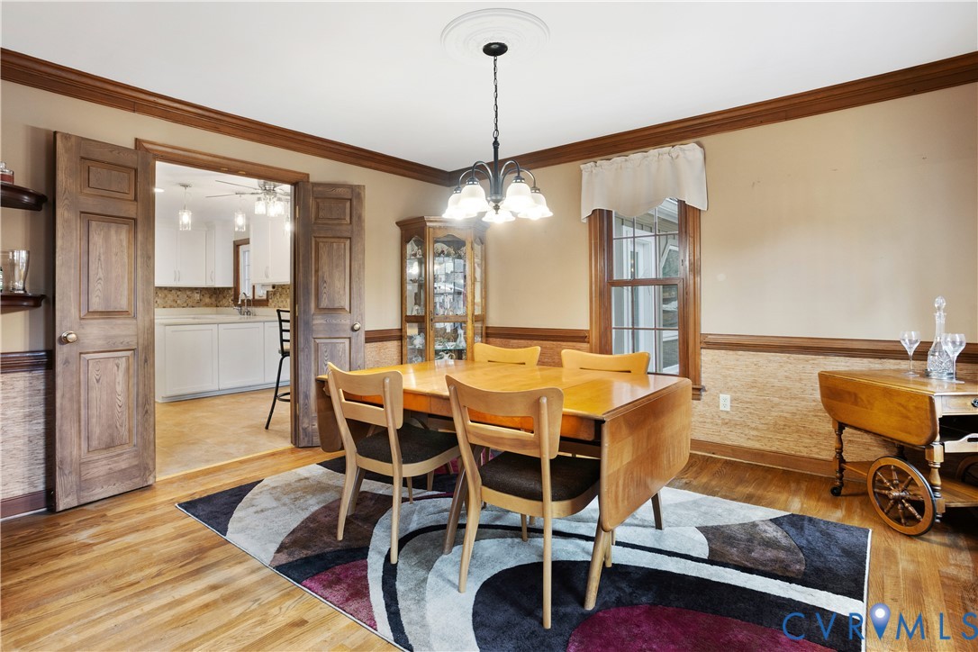 3613 Stoney Ridge Road Midlothian, VA 23112 - Photo 9 of 50 a dining room with furniture a chandelier and wooden floor