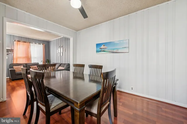 a view of a a dining room with furniture window and wooden floor