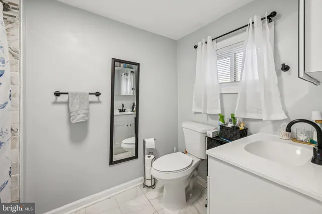a bathroom with a toilet a sink and shower