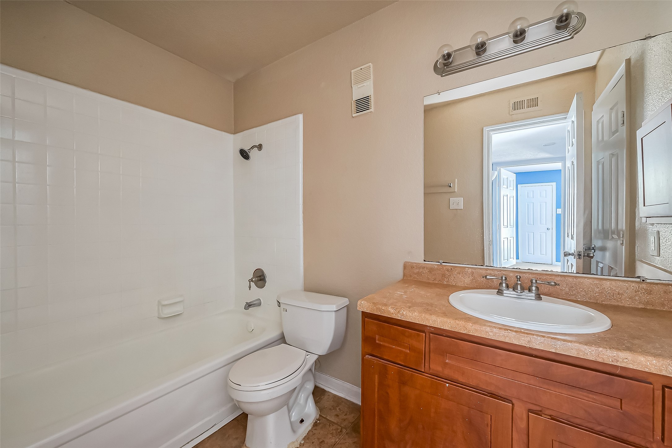 8100 Creekbend Drive, Unit 146 Houston, TX 77071 - Photo 17 of 17 a bathroom with a granite countertop sink a toilet and a mirror