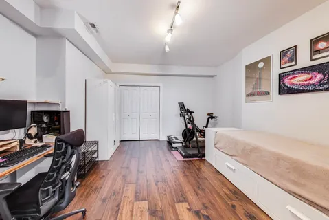 a bedroom with furniture and a wooden floor
