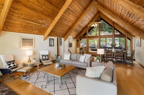 a living room with patio furniture and a large window