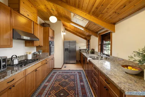 a large kitchen with granite countertop lots of counter top space