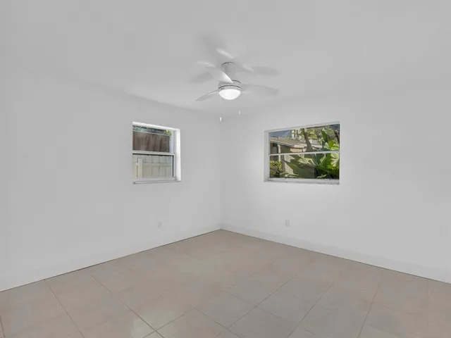 a view of a livingroom with an empty space and a window