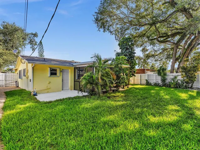 an aerial view of a house with a yard basket ball court and outdoor seating