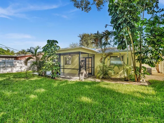 an aerial view of a house with a yard basket ball court and outdoor seating
