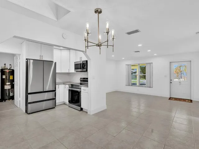 a kitchen with stainless steel appliances granite countertop a refrigerator stove and microwave