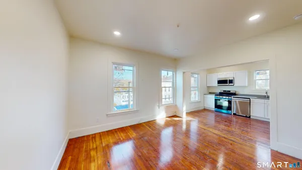 a view of a kitchen with microwave and windows