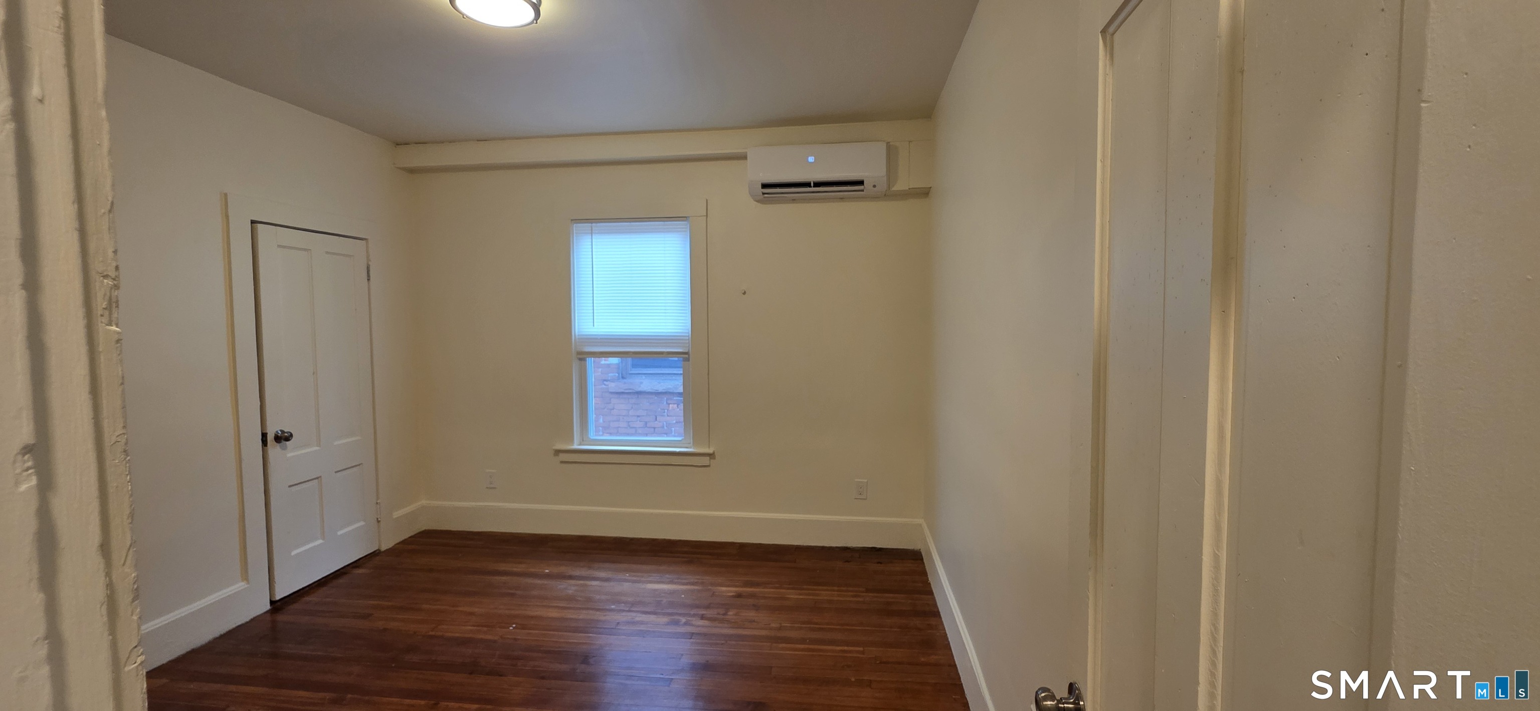 736 Main Street Windham, CT 06226 - Photo 15 of 16 a view of an empty room with wooden floor and a window