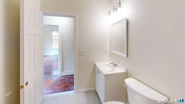a bathroom with a sink toilet vanity and tub