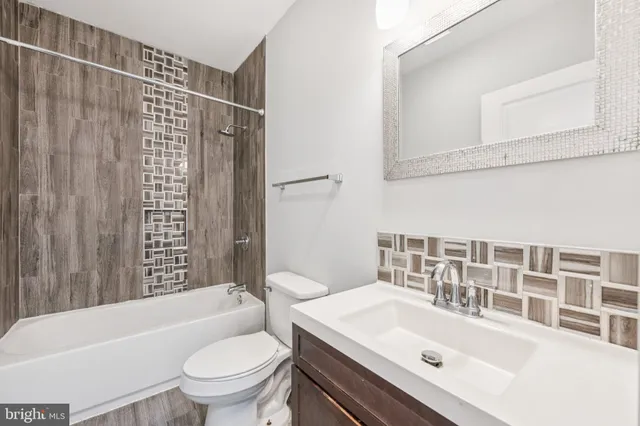 a bathroom with a sink a toilet and a bathtub